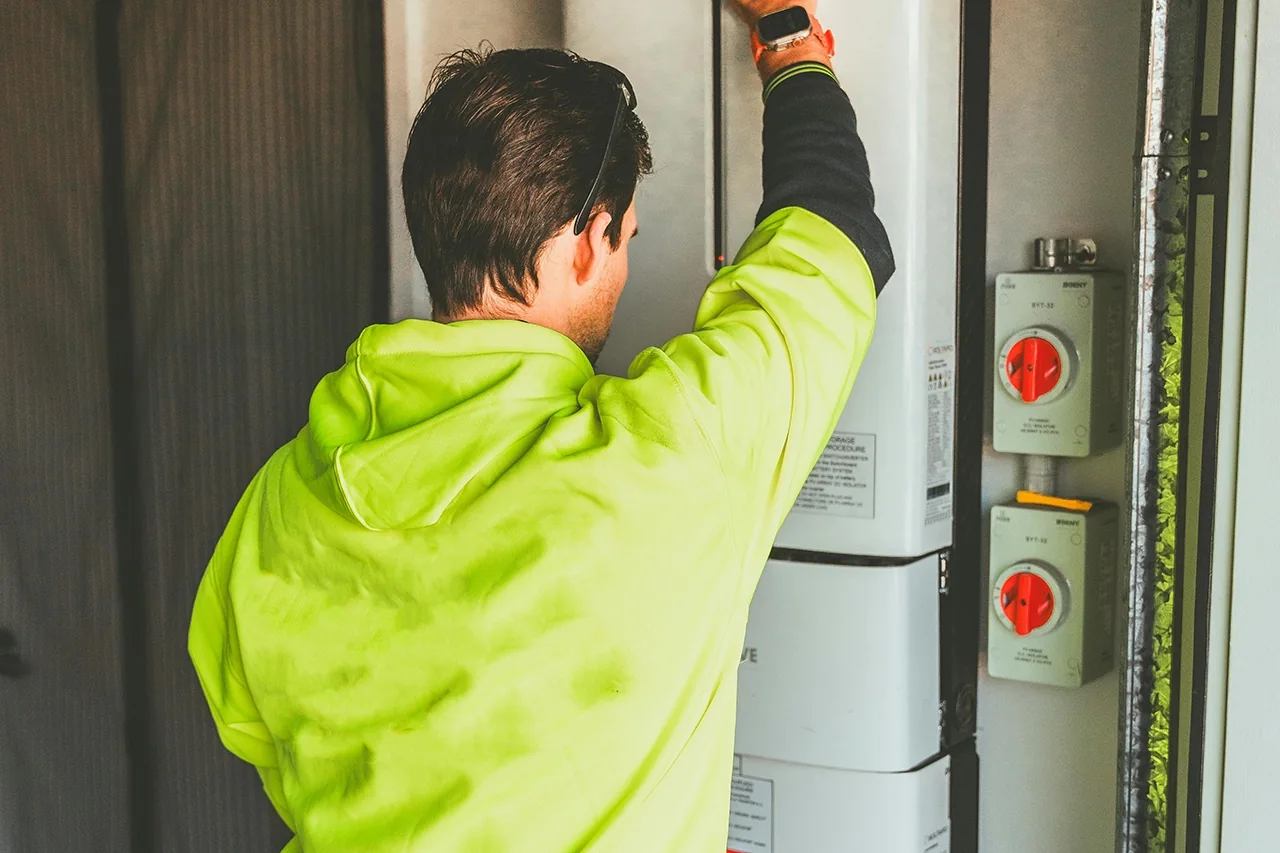 Iconic Energy electrician installing a modular home battery in Hobart