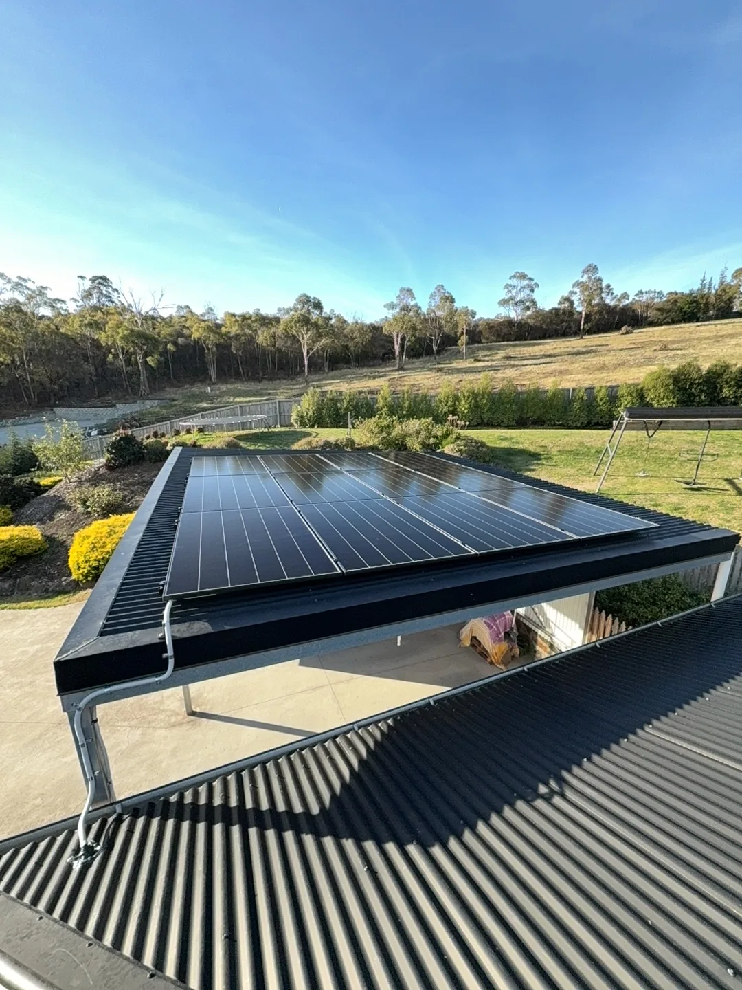 Solar panels on the lower roof above the carport