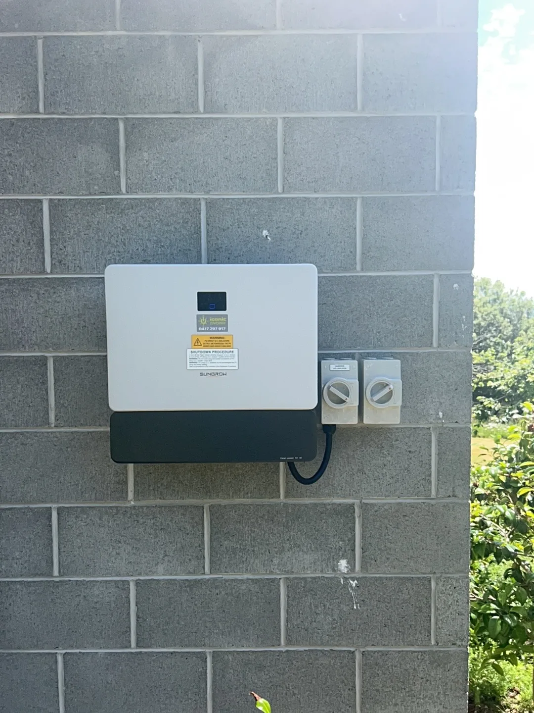 Hybrid inverter and isolators mounted on the block wall