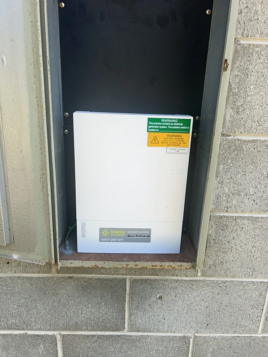 Sungrow hybrid inverter installed in a recess beside the house