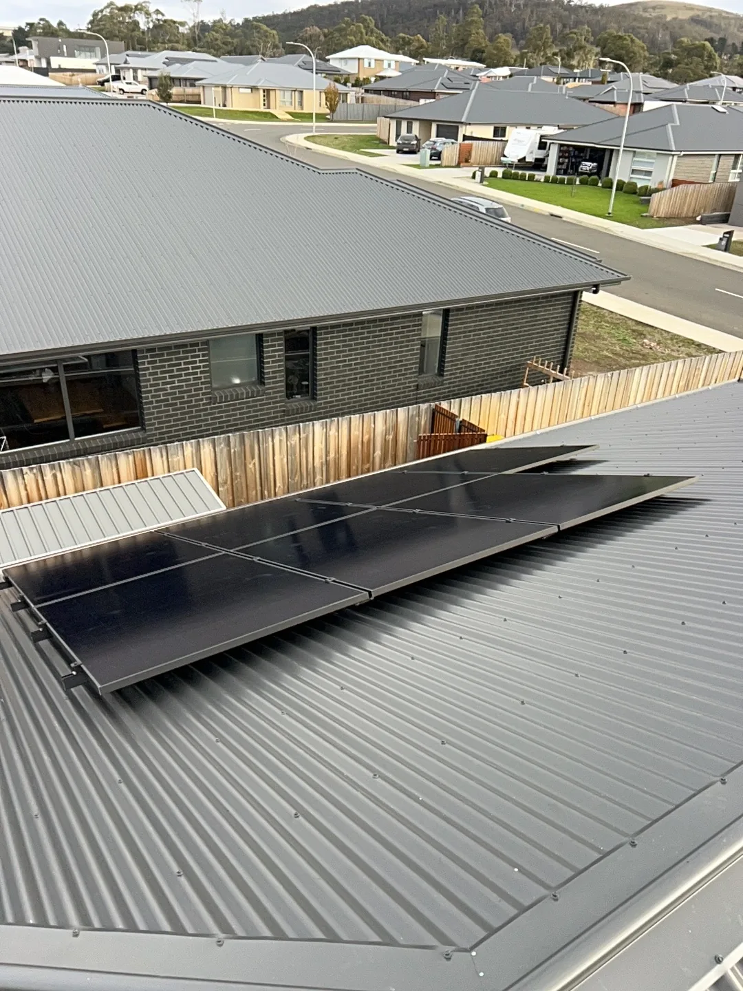 Solar panels on the roof looking out across the surrounding street