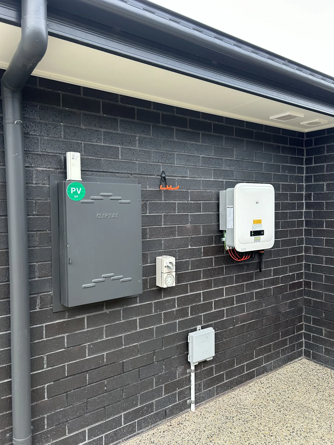 Inverter, PV isolator and switchgear grouped on the exterior wall