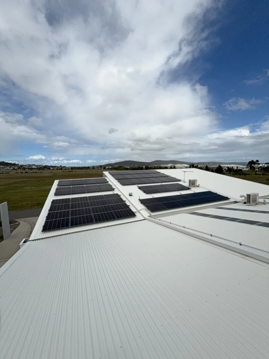 Panel rows spread across the commercial roof sheeting
