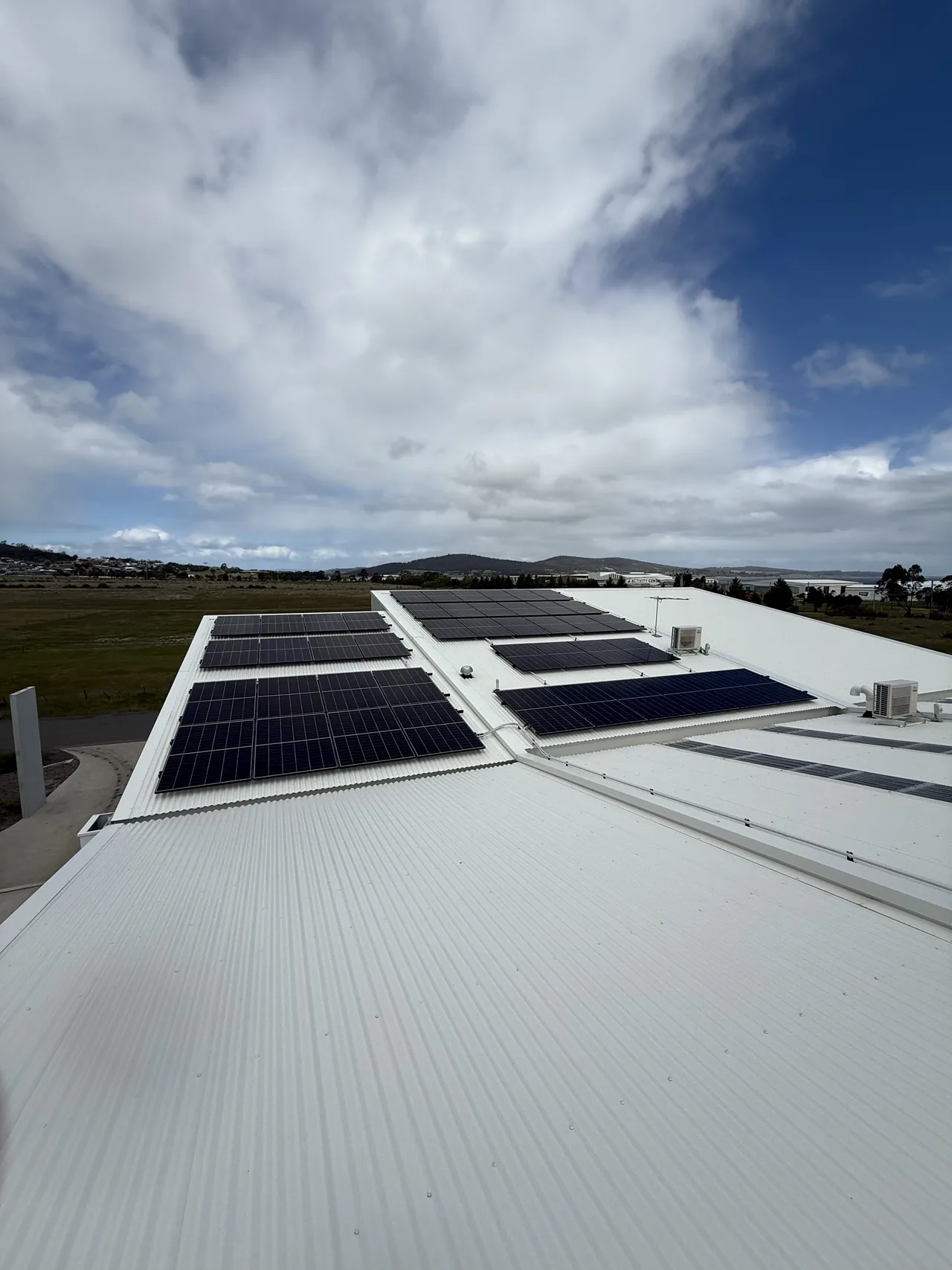 Rows of solar panels across a large commercial roof at Rokeby