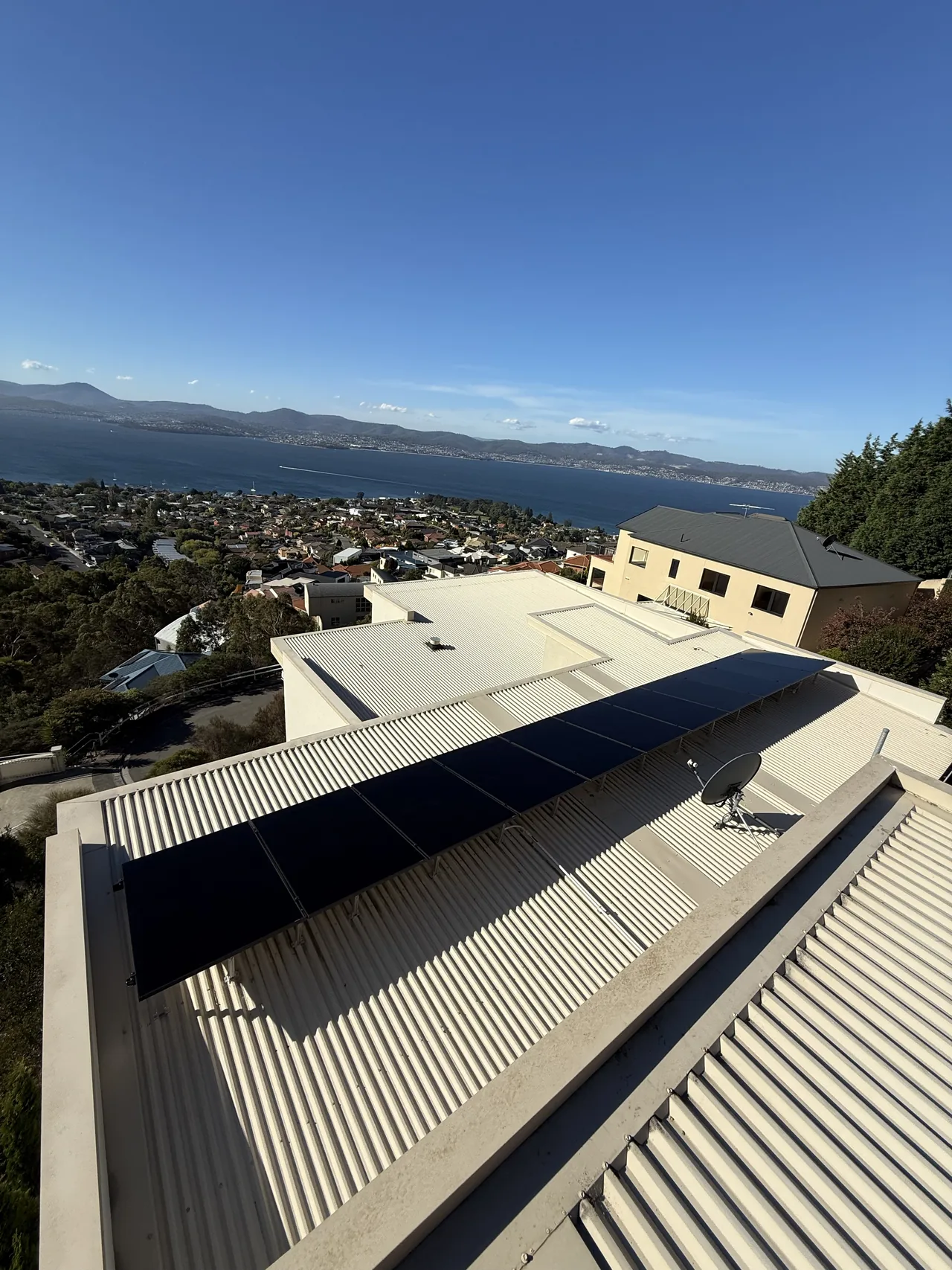 The array along the roof with the river and city below