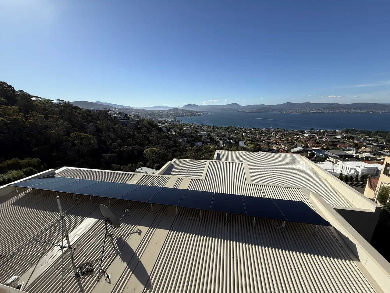 Solar panels on a Sandy Bay roof high above the Derwent